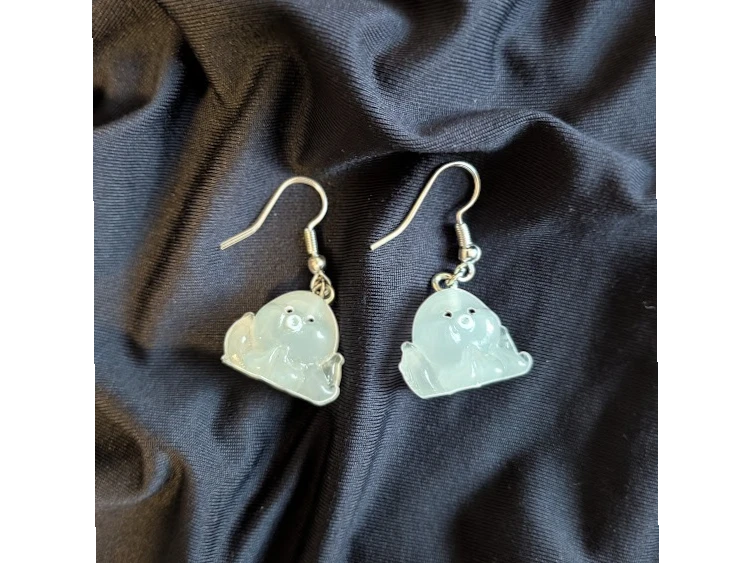 UniquelyYou translucent pale blue resin ghost earrings with black eyes and silver hooks. Whimsical and cute.