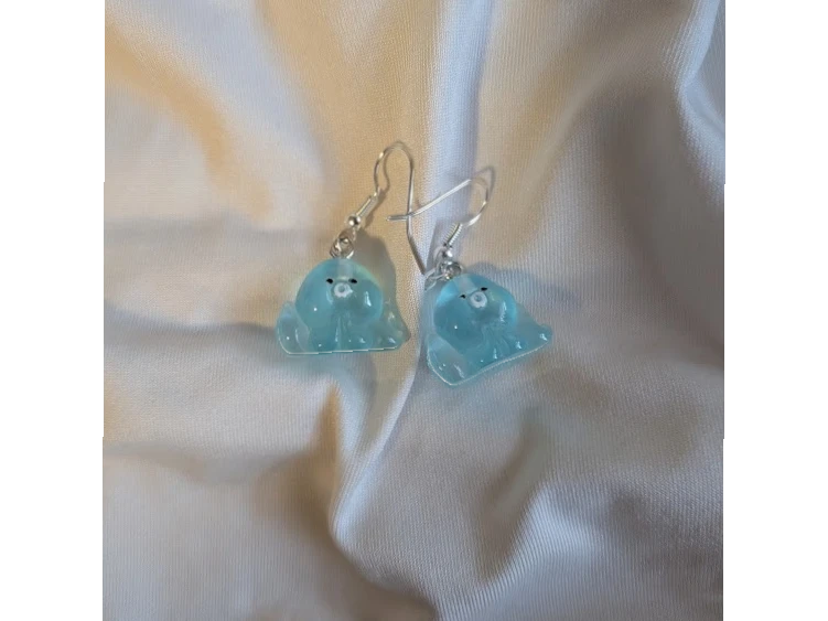 UniquelyYou blue translucent resin ghost earrings with black eyes and white center. Whimsical and playful design.