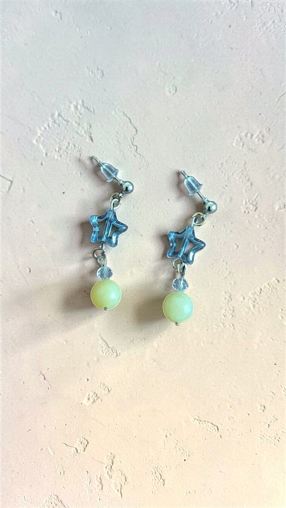 UniquelyYou translucent blue star charm drop earrings with pale yellow beads and clear accent beads.