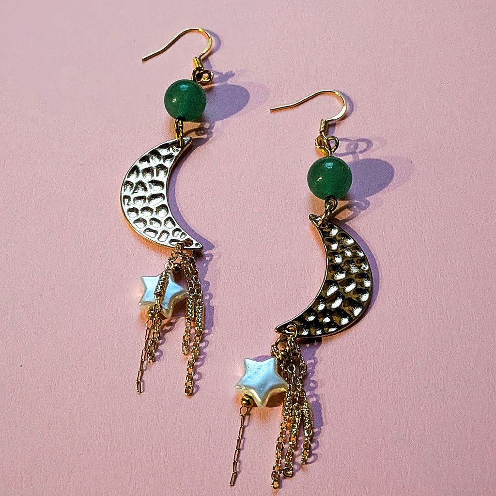 UniquelyYou gold-tone celestial drop earrings with textured crescent moons, green beads, star charms, and tassels.