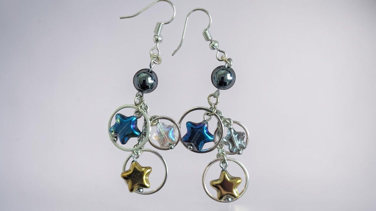 UniquelyYou Celestial star charm dangle earrings with blue, gold, and iridescent stars on silver-tone hoops.