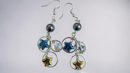 UniquelyYou Celestial star charm dangle earrings with blue, gold, and iridescent stars on silver-tone hoops.