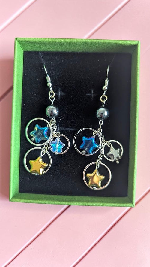 UniquelyYou Celestial star dangle earrings with blue, gold, and silver charms on silver-tone hooks.