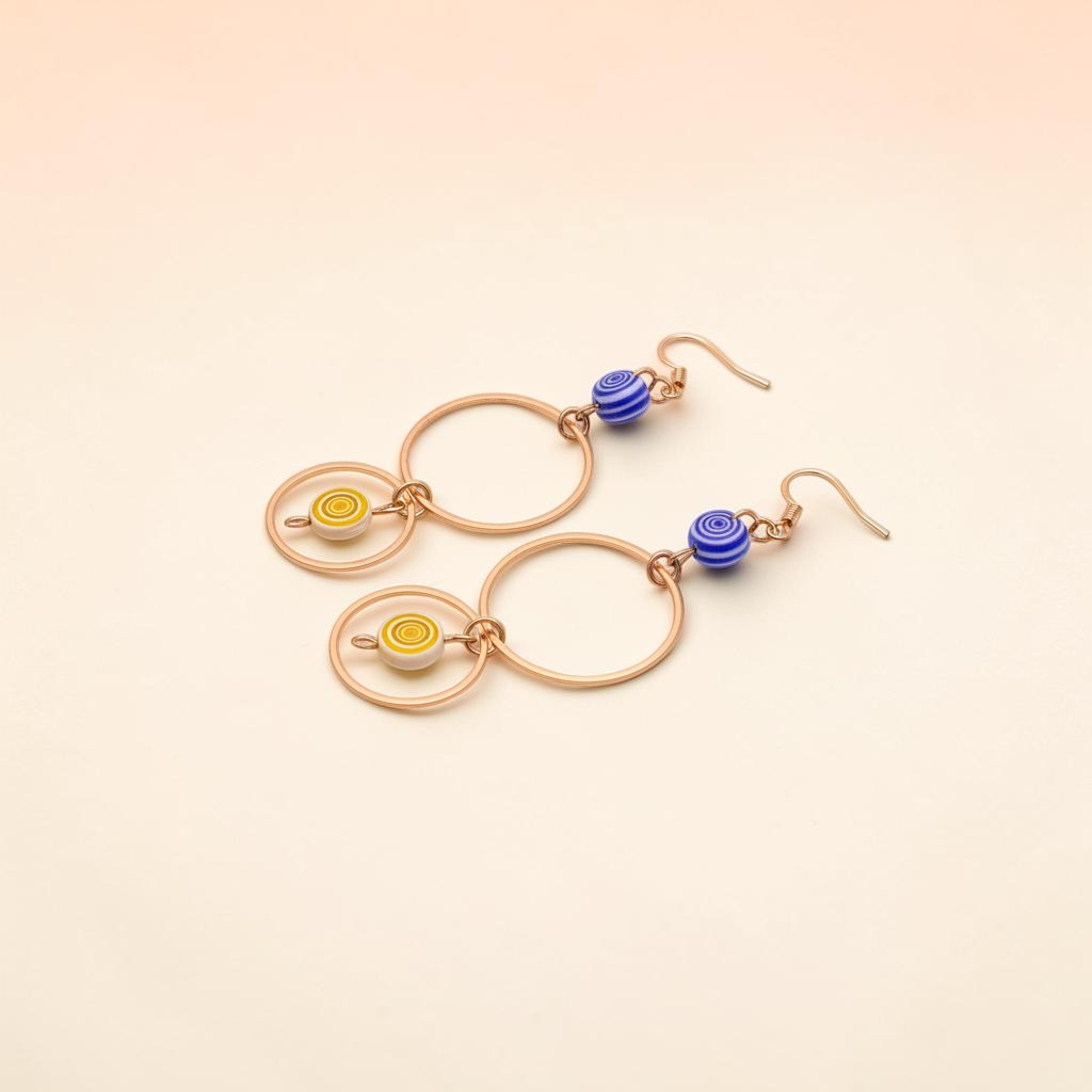 UniquelyYou geometric gold-tone hoop earrings with blue and yellow swirled beaded accents.