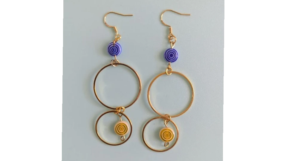UniquelyYou gold-tone double hoop earrings with blue and yellow swirled beads.