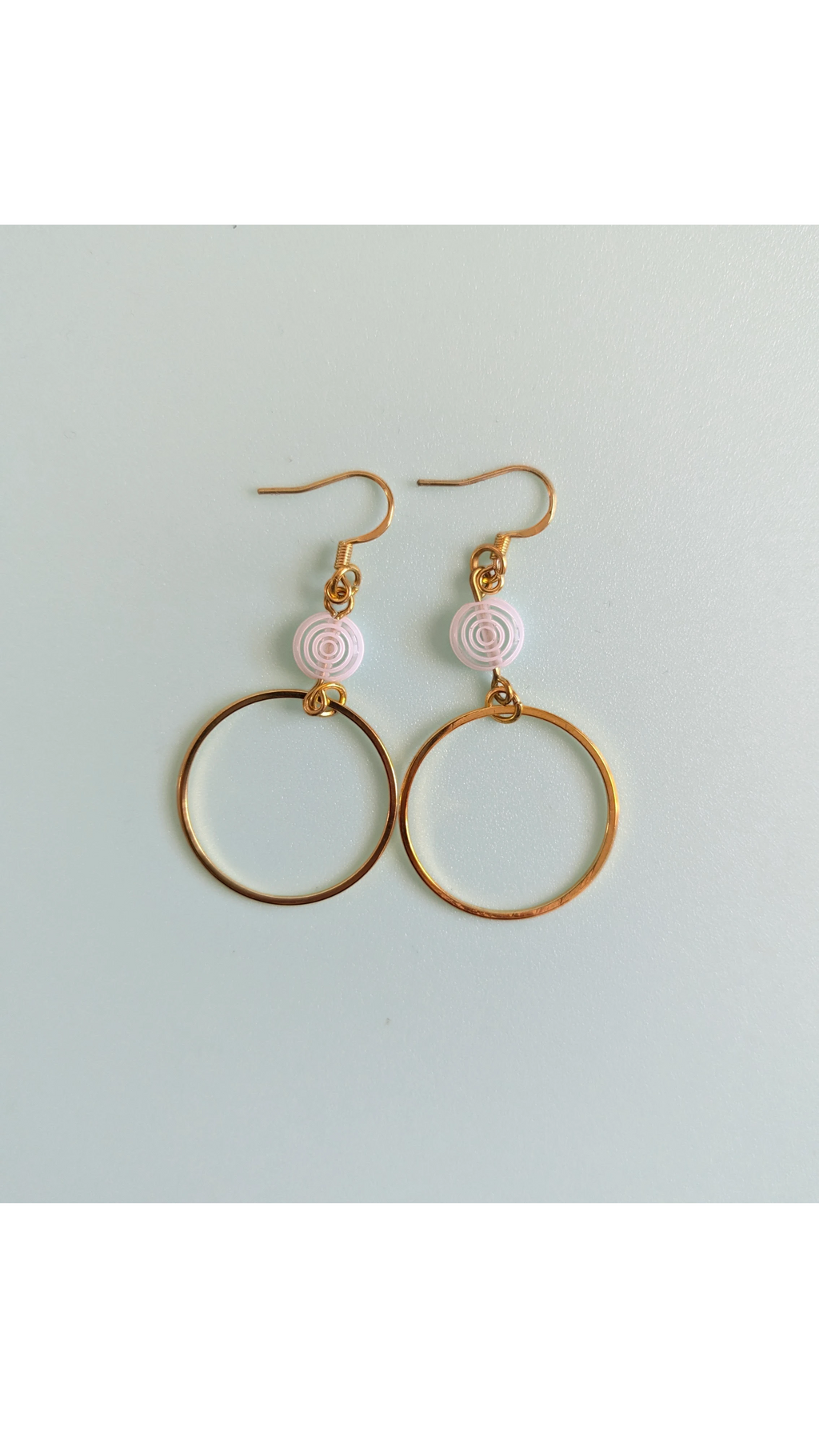 UniquelyYou gold-tone hoop earrings with white spiral beads. Delicate and elegant, perfect for everyday wear.