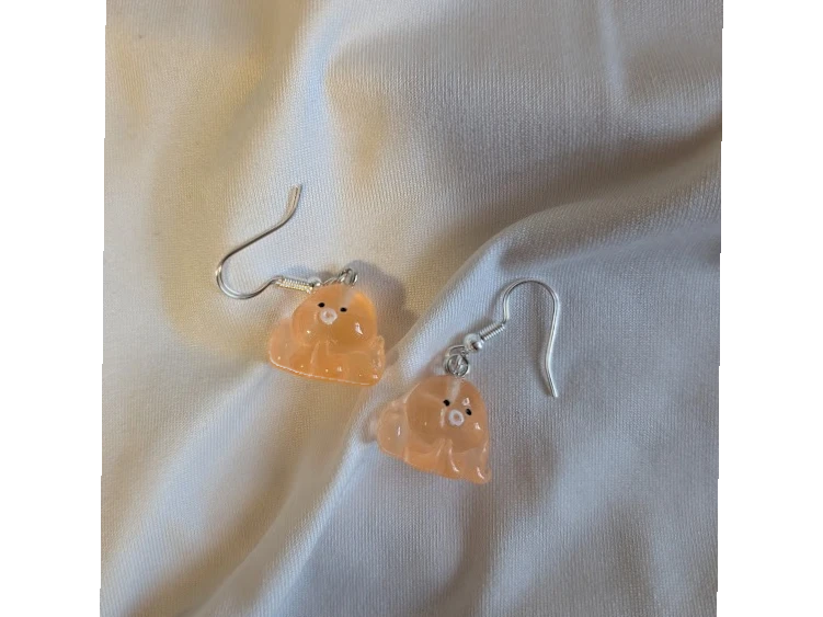 UniquelyYou peach translucent resin ghost earrings with black eyes and white center.